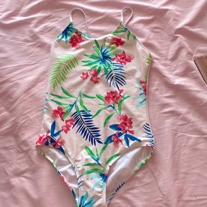This is a one piece bathing suit from kanu surf with a tropical floral design.